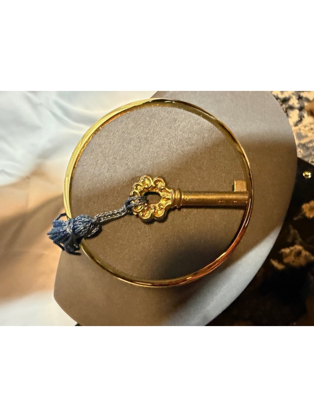 Vintage style brass key brooch with blue tassel